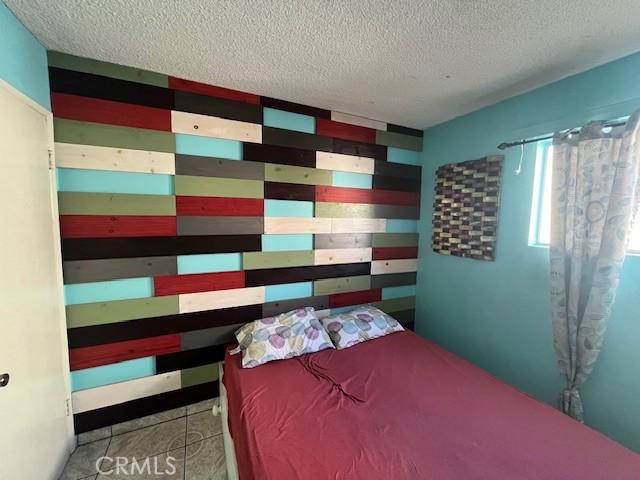 3804 Broadway Unit 3804, Huntington Park, CA 90255 - bedroom featuring a textured ceiling and wood walls