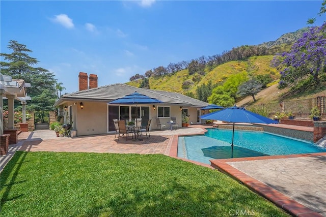 2082 Kaia Ln, Sierra Madre, CA 91024 - back of property with a chimney, a patio, and stucco siding