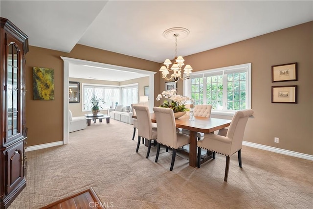 2082 Kaia Ln, Sierra Madre, CA 91024 - dining space featuring a chandelier, healthy amount of natural light, and light colored carpet