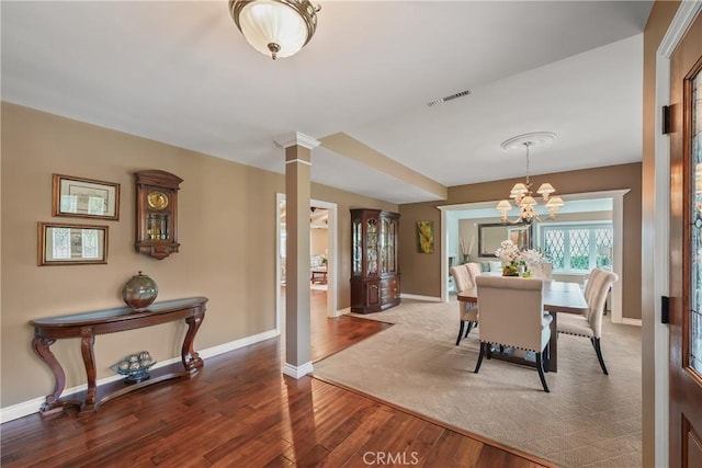 2082 Kaia Ln, Sierra Madre, CA 91024 - dining area with wood finished floors, a chandelier, and decorative columns