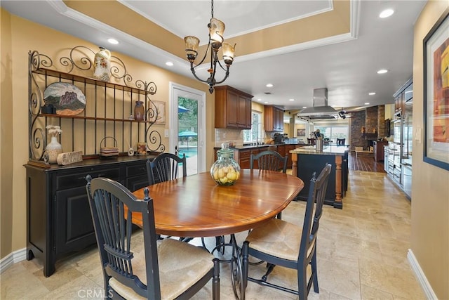 2082 Kaia Ln, Sierra Madre, CA 91024 - dining space with a tray ceiling, a chandelier, recessed lighting, light stone finish floors, and ornamental molding