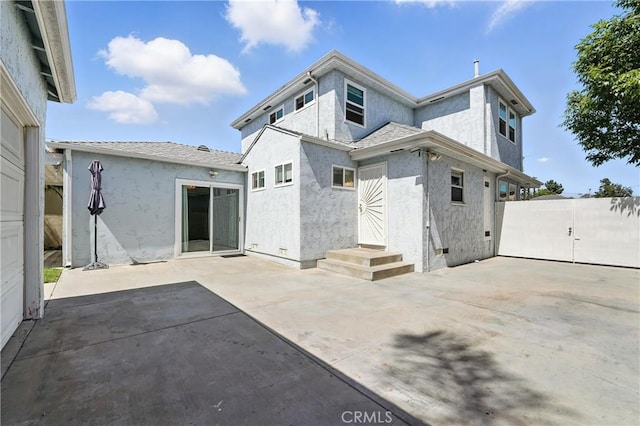 2275 Ximeno Ave, Long Beach, CA 90815 - back of property with stucco siding, a patio, and a gate