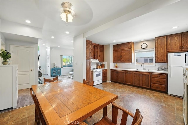 2275 Ximeno Ave, Long Beach, CA 90815 - kitchen featuring white appliances, healthy amount of natural light, a ceiling fan, recessed lighting, and light countertops