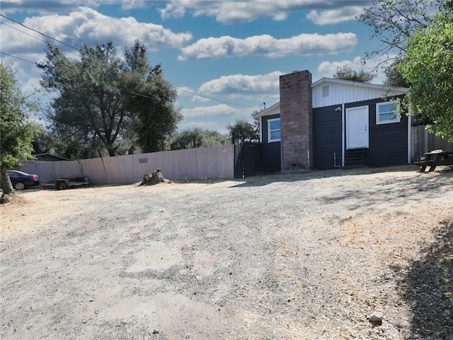 3450 10th St, Clearlake, CA 95422 - view of side of home with entry steps and a chimney