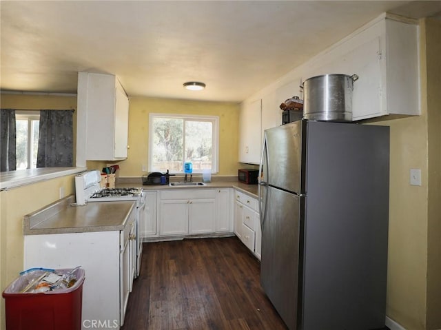 3450 10th St, Clearlake, CA 95422 - kitchen featuring freestanding refrigerator, gas range gas stove, dark wood-style flooring, and plenty of natural light