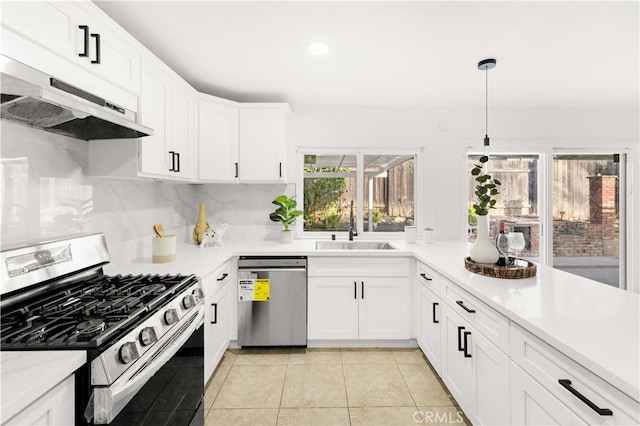 7293 Macy Ct, Riverside, CA 92503 - kitchen featuring appliances with stainless steel finishes, under cabinet range hood, light countertops, light tile patterned floors, and white cabinetry