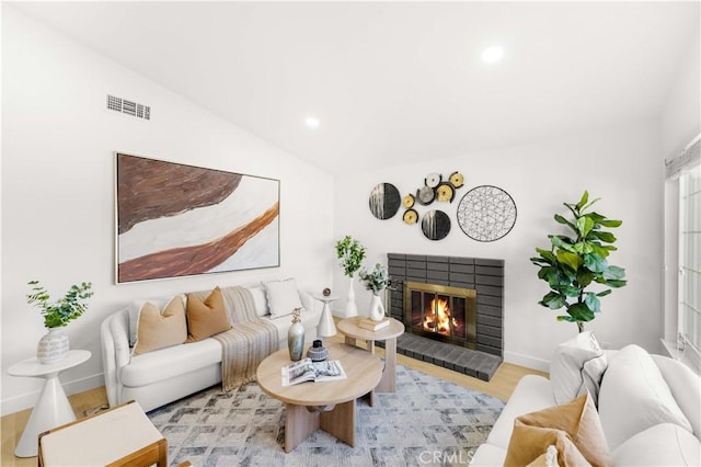 7293 Macy Ct, Riverside, CA 92503 - living room with a brick fireplace, wood finished floors, recessed lighting, and vaulted ceiling