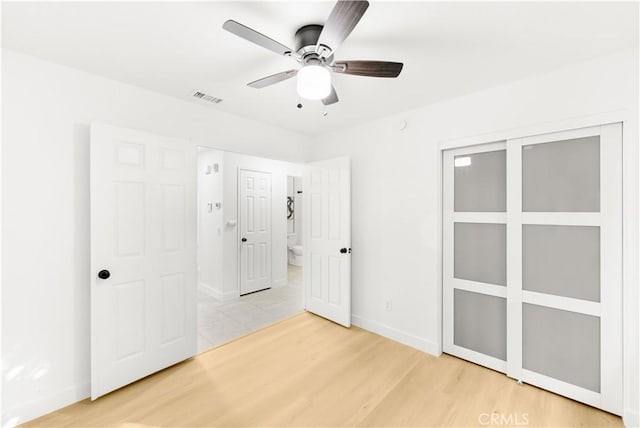 7293 Macy Ct, Riverside, CA 92503 - unfurnished bedroom featuring light wood-style flooring, ceiling fan, and a closet