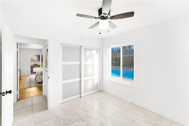 7293 Macy Ct, Riverside, CA 92503 - empty room featuring healthy amount of natural light, light tile patterned floors, and ceiling fan