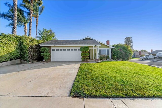 7293 Macy Ct, Riverside, CA 92503 - view of front of property featuring a front yard, an attached garage, driveway, and a chimney