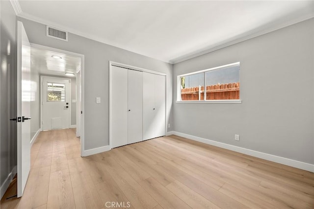 1141 N Palm St, La Habra, CA 90631 - unfurnished bedroom with multiple windows, light wood-type flooring, a closet, and crown molding