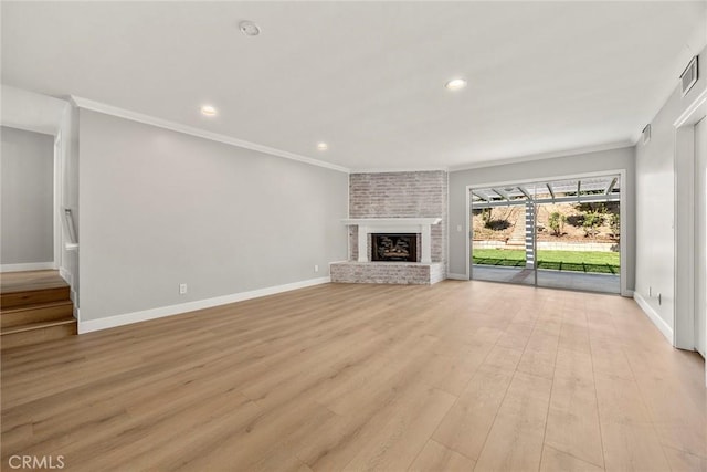 1141 N Palm St, La Habra, CA 90631 - unfurnished living room with ornamental molding, a fireplace, recessed lighting, and light wood-style flooring