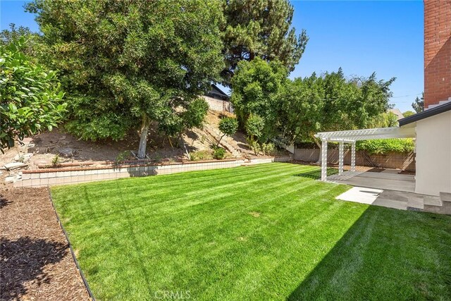 1141 N Palm St, La Habra, CA 90631 - fenced backyard featuring a pergola and a patio area