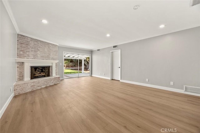 1141 N Palm St, La Habra, CA 90631 - unfurnished living room featuring a brick fireplace, crown molding, wood finished floors, and recessed lighting
