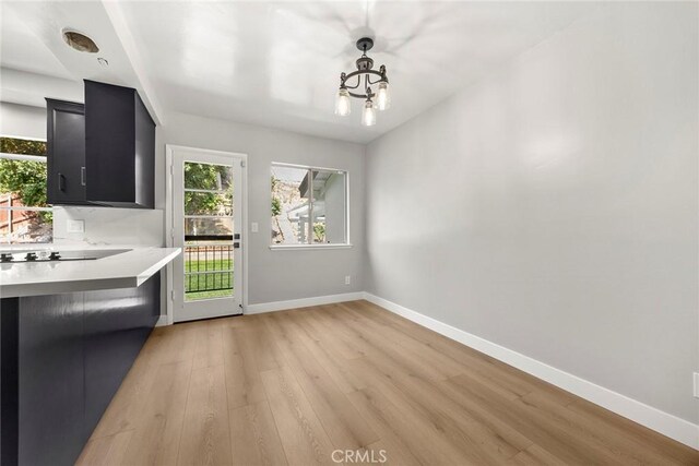 1141 N Palm St, La Habra, CA 90631 - unfurnished dining area featuring healthy amount of natural light, light wood-style floors, and a chandelier