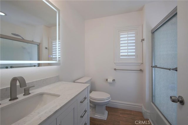 7 Luzern, Mission Viejo, CA 92692 - bathroom featuring vanity, wood finished floors, and bath / shower combo with glass door