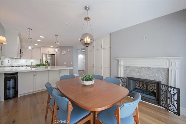 7 Luzern, Mission Viejo, CA 92692 - dining room with wine cooler, light wood finished floors, recessed lighting, and a fireplace