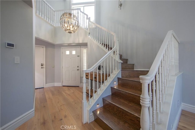 7 Luzern, Mission Viejo, CA 92692 - foyer entrance featuring wood finished floors, stairway, a chandelier, and a towering ceiling