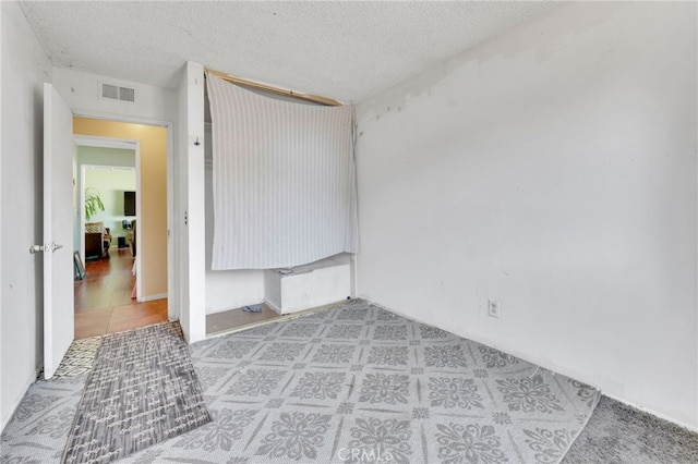 1926 E 7th St, Ontario, CA 91764 - spare room featuring a textured ceiling and light tile patterned floors