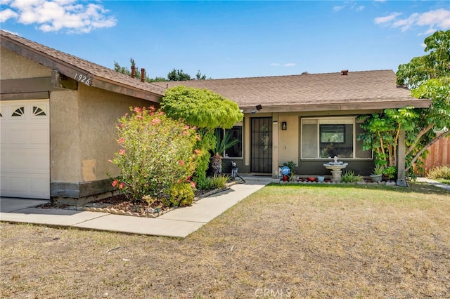 1926 E 7th St, Ontario, CA 91764 - view of front of property with stucco siding, a garage, and a front yard