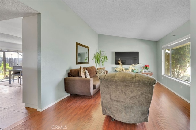 1926 E 7th St, Ontario, CA 91764 - living area with a textured ceiling, vaulted ceiling, and wood finished floors