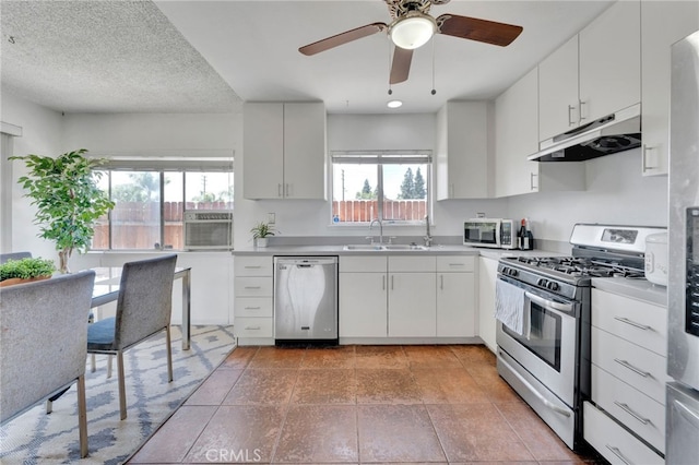 1926 E 7th St, Ontario, CA 91764 - kitchen featuring appliances with stainless steel finishes, under cabinet range hood, plenty of natural light, and ceiling fan