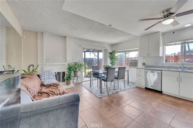 1926 E 7th St, Ontario, CA 91764 - kitchen featuring stainless steel dishwasher, healthy amount of natural light, a ceiling fan, a textured ceiling, and white cabinetry