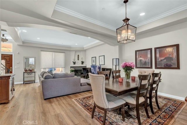 14535 Margate St Unit 13, Sherman Oaks, CA 91411 - dining area with a raised ceiling, light wood finished floors, a chandelier, crown molding, and a fireplace