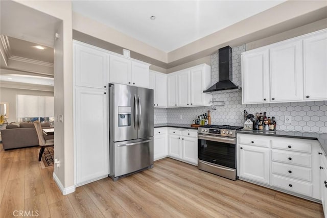 14535 Margate St Unit 13, Sherman Oaks, CA 91411 - kitchen with appliances with stainless steel finishes, wall chimney exhaust hood, dark countertops, light wood finished floors, and crown molding
