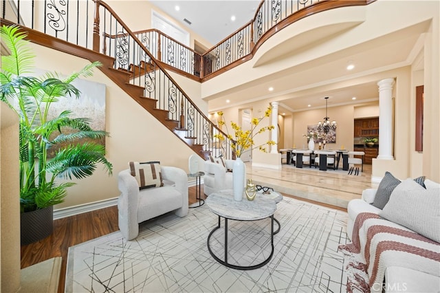 2 Cresta Del Sol, San Clemente, CA 92673 - living room featuring ornate columns, crown molding, stairway, wood finished floors, and a chandelier