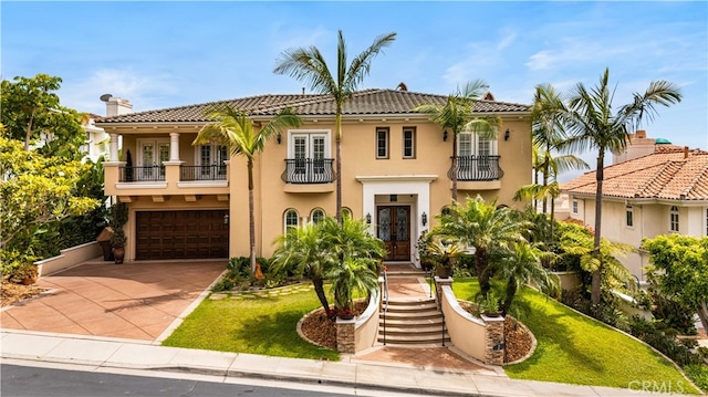2 Cresta Del Sol, San Clemente, CA 92673 - mediterranean / spanish-style home featuring a balcony, french doors, a front yard, and driveway