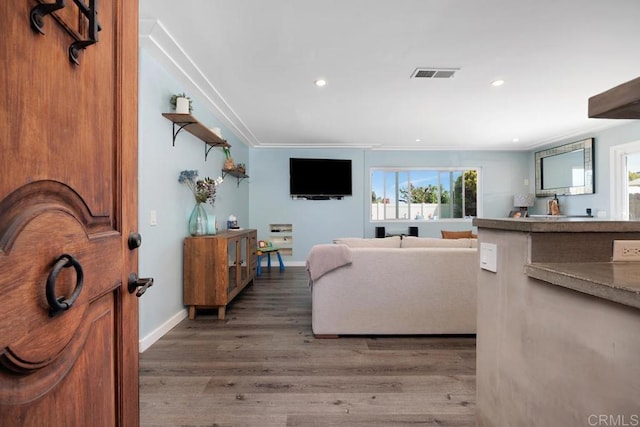 3985 Shenandoah Dr, Oceanside, CA 92056 - living room with wood finished floors, recessed lighting, and ornamental molding