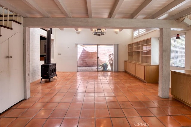 1878 Molino Ave N, Signal Hill, CA 90755 - unfurnished living room featuring beamed ceiling, tile patterned flooring, and a wood stove