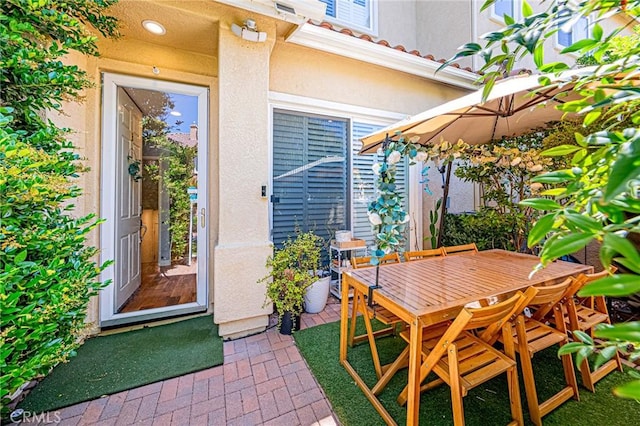 25748 Perlman Pl Unit B, Stevenson Ranch, CA 91381 - entrance to property with stucco siding, a patio area, and outdoor dining area