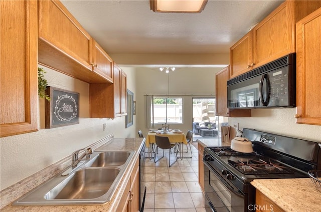 315 Spencer Ave, Upland, CA 91786 - kitchen featuring black appliances, light countertops, light tile patterned floors, and brown cabinetry