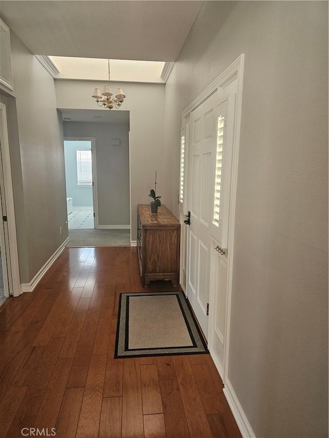 41710 Crispi Ln, Lancaster, CA 93536 - foyer with a chandelier and dark wood-style flooring
