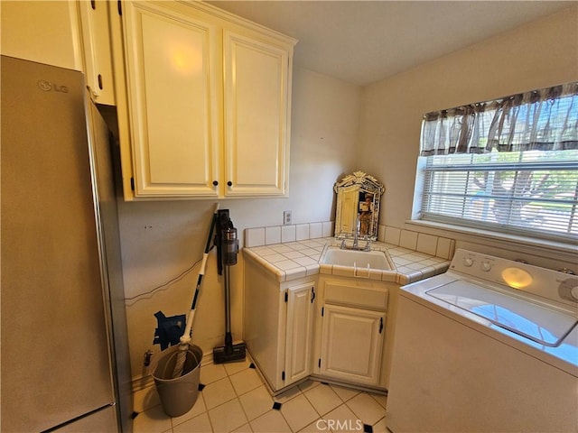 41710 Crispi Ln, Lancaster, CA 93536 - laundry room featuring washer / clothes dryer, cabinet space, and light tile patterned floors