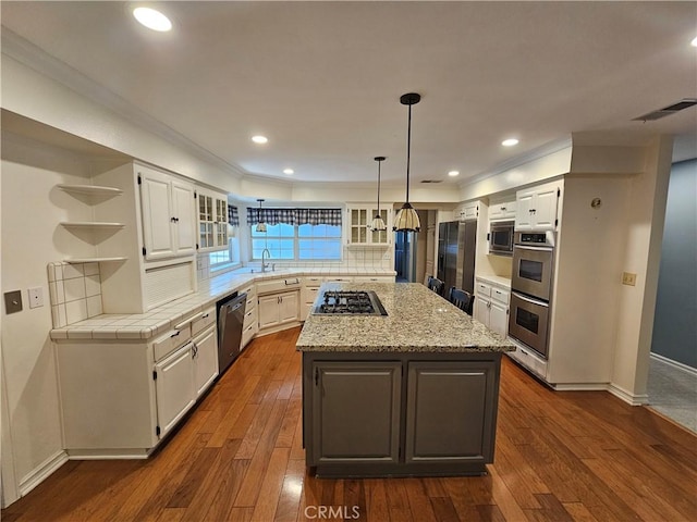 41710 Crispi Ln, Lancaster, CA 93536 - kitchen with appliances with stainless steel finishes, open shelves, white cabinetry, ornamental molding, and decorative backsplash