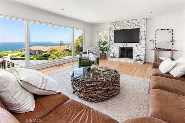 556 Via Media, Palos Verdes Estates, CA 90274 - living area featuring ornamental molding, wood finished floors, a water view, and a fireplace