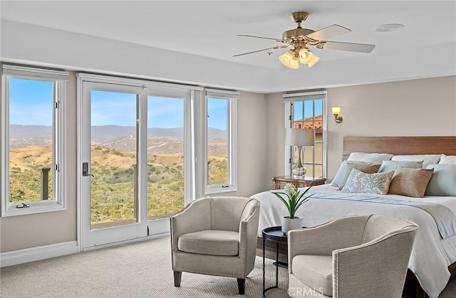 870 Avenida Acapulco, San Clemente, CA 92672 - bedroom with light colored carpet, multiple windows, a mountain view, and a ceiling fan