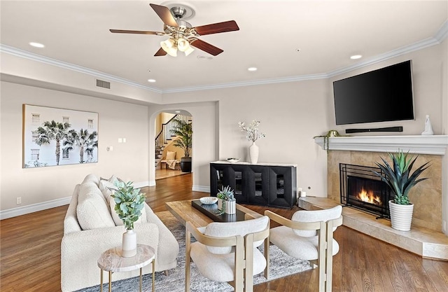 870 Avenida Acapulco, San Clemente, CA 92672 - living area featuring wood finished floors, arched walkways, a premium fireplace, ornamental molding, and ceiling fan