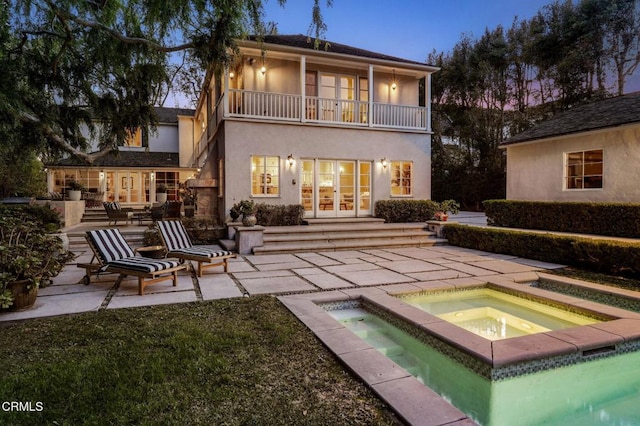 980 El Campo Dr, Pasadena, CA 91107 - back of property featuring french doors, a balcony, an in-ground hot tub, stucco siding, and a patio