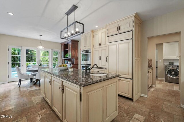 980 El Campo Dr, Pasadena, CA 91107 - kitchen with washer / clothes dryer, stone tile floors, paneled built in fridge, an island with sink, and recessed lighting