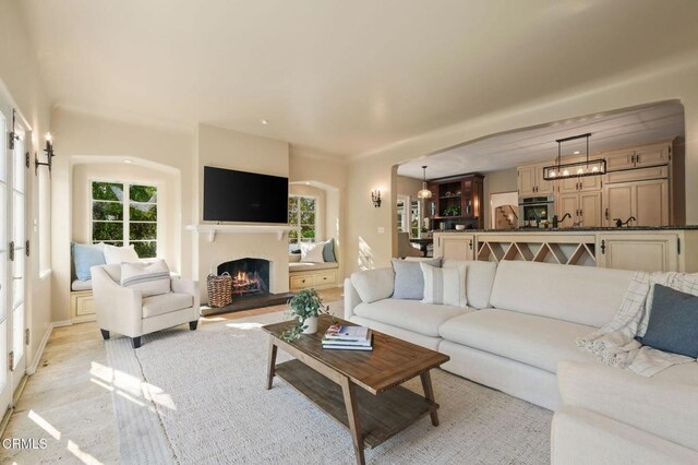 980 El Campo Dr, Pasadena, CA 91107 - living area featuring healthy amount of natural light and a lit fireplace
