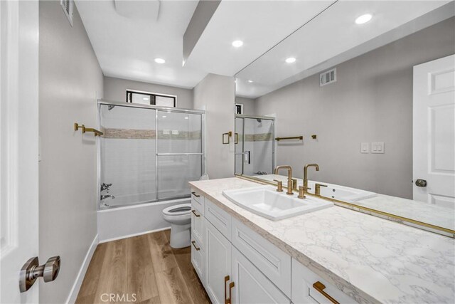 247 El Cielo Ln, Bradbury, CA 91008 - bathroom with vanity, wood finished floors, bath / shower combo with glass door, and recessed lighting