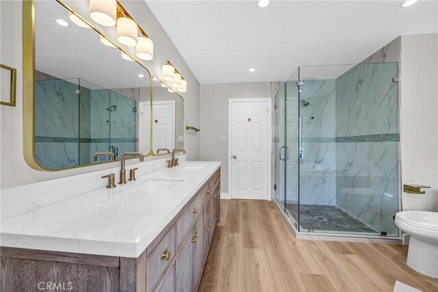 247 El Cielo Ln, Bradbury, CA 91008 - bathroom featuring wood finished floors, double vanity, recessed lighting, and a marble finish shower