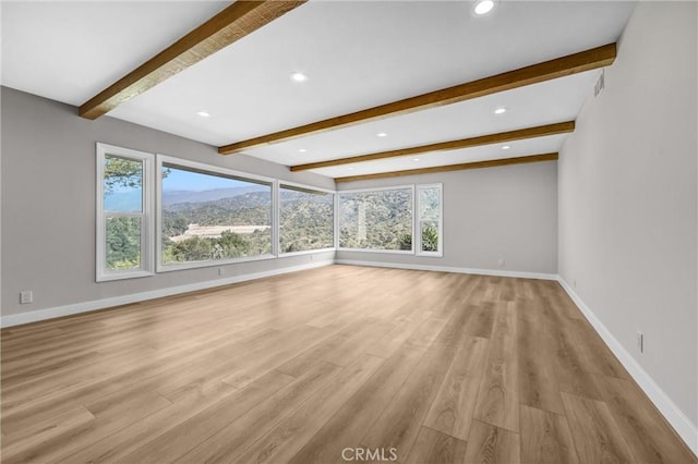 247 El Cielo Ln, Bradbury, CA 91008 - unfurnished living room featuring beamed ceiling, plenty of natural light, light wood finished floors, and recessed lighting