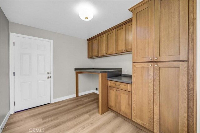 247 El Cielo Ln, Bradbury, CA 91008 - laundry room with light wood-type flooring and cabinet space