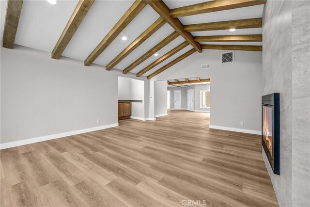 247 El Cielo Ln, Bradbury, CA 91008 - unfurnished living room with a large fireplace, recessed lighting, beam ceiling, light wood-style floors, and high vaulted ceiling