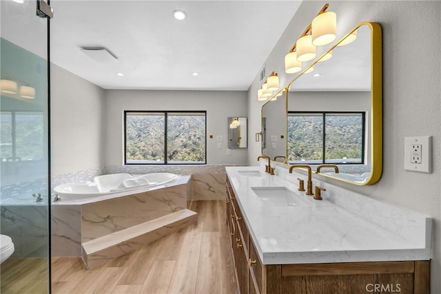 247 El Cielo Ln, Bradbury, CA 91008 - full bath featuring a garden tub, wood finished floors, double vanity, a marble finish shower, and recessed lighting
